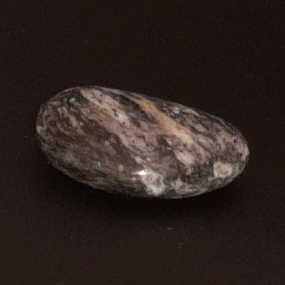 Polished Granite Black and White with some brown. Oval Shape Approx. 2 cm