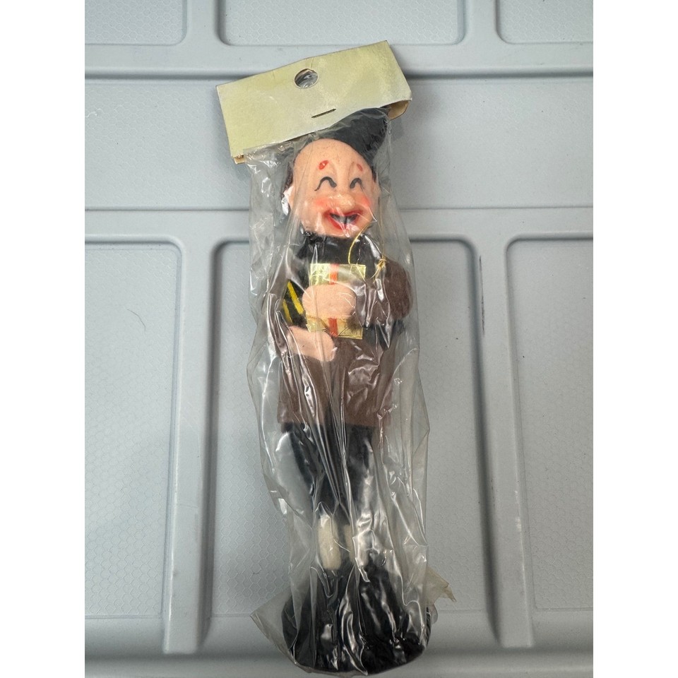 A dead-ringer for the charming MCM kitsch your grandma had on her mantle — a felt-costumed Made-in-Japan Christmas figurine that nails the mid-century holiday aesthetic.