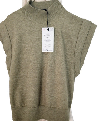 zara Plain knit top with high collar and sleeveless cut with pointed shoulders.