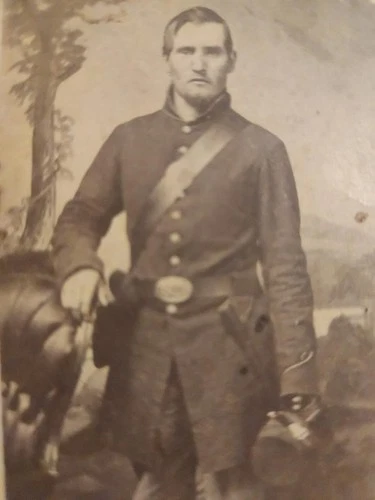 Civil War soldier w/gear in frock coat with cap in hand and Elmira, NY, backmark