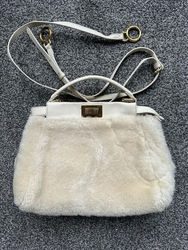 Fendi Mini Peekaboo satchel bag in shearling with gold-tone hardware.