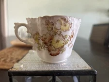 Aynsley China Tea Cup Made Of Bone. Its Base Is White W/ Multicolored Flowers.