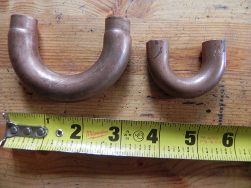 Two copper u fittings
