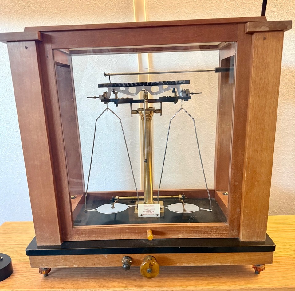 A genuine Voland & Sons brass analytical balance — the kind of exquisitely crafted scientific instrument that turns any room into a Victorian apothecary or alchemist's lab.