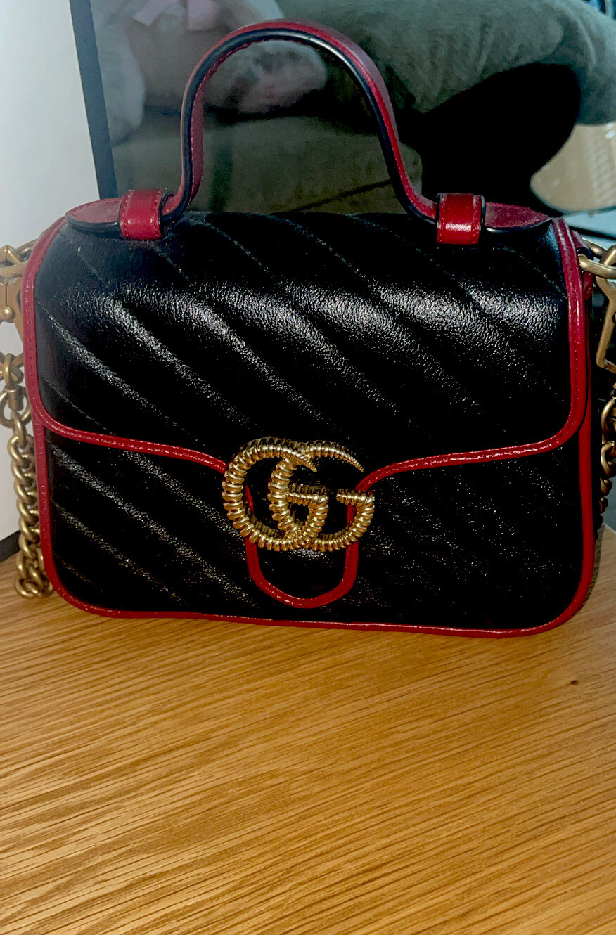 Authentic Gucci Marmont Black Red Quilted Leather Bag with Gold GG Chain.