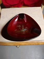 Vintage porcelain cigar ashtray black base rests and rim bowl is ox blood with 