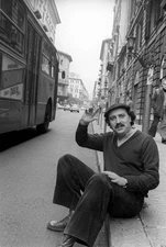 Italian writer poet Giuseppe Conte gesticulating sitting on a side- Old Photo