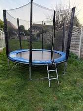 Round garden trampoline with blue spring padding, black safety net.