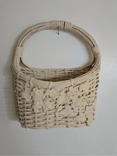 Woven basket wall decor with grape vine design