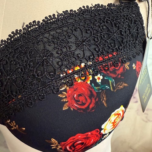 Black padded underwire bra with red rose floral print, black lace trim, and “38D” tag at the side.