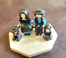 VINTAGE SET OF FAMILY OF 4 CAST IRON MINIATURE AMISH FIGURINES ON BENCH