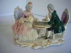 142 -- German Porcelain Figurine Couple Sitting At A Game Table