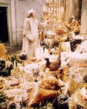 Albert Finney as Scrooge surrounded by Christmas gifts 24x36 inch Poster Albert Finney as Scrooge surrounded by Christmas gifts 24x36 inch Poster