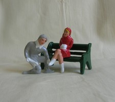 Ice Skaters on bench, man helping woman w/skates, winter scene train layout