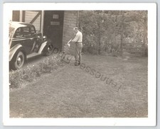 Photo A Man Spraying His Plants And Flowers Black And White