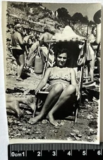 Beautiful young woman in a swimsuit on the beach, bare legs, Foot old photo