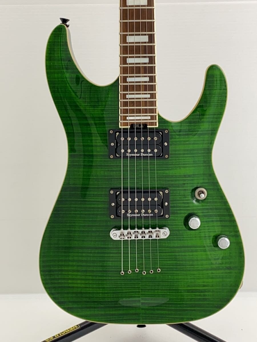 Green SCHECTER PA-SW/TH/See-Thru electric guitar with silver hardware, black pickups, and flamed maple fretboard.
