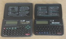 Set Of 2 Seiko Instruments SII Berlitz Spanish-English Translator Handheld