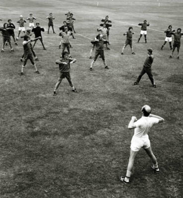 The Arsenal squad limber up with physio Fred Street during trainin- Old Photo