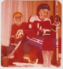 Two Teen Hockey Players Gear Up in Full Uniforms Ready to Hit the Ice Young Men