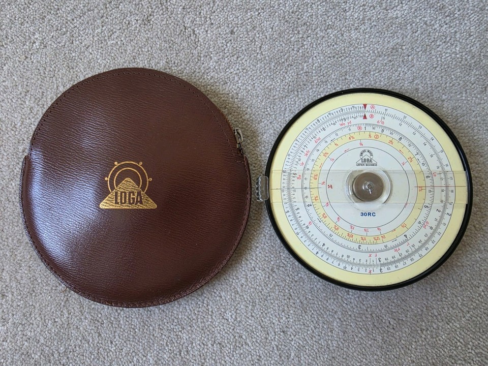 A Swiss-made LOGA circular slide rule — a double-sided disc of analogue computing elegance that looks like it belongs in a Bond villain's lair.