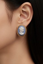 Elegant blue and white oval cameo earrings in a gold frame setting . Small