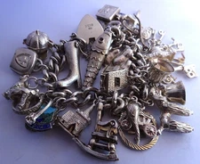 Vintage 101.3g solid silver charm bracelet,many curious silver charms inc moving