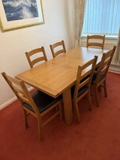 Light oak solid wood extending dining table and 6 chairs.
