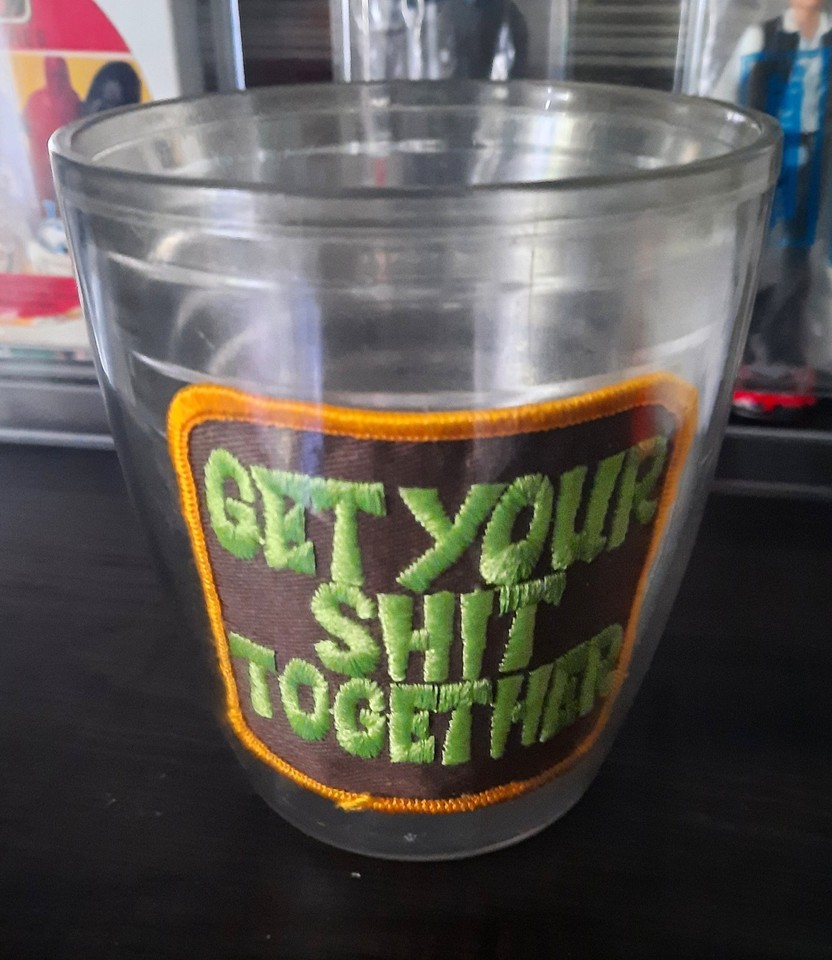 A 1970s thermal tumbler with an actual sewn-on motivational patch — time-capsule drinkware that feels like it came straight out of a dad's bowling bag.