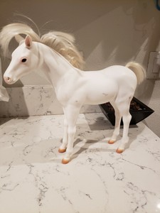 white plastic horse