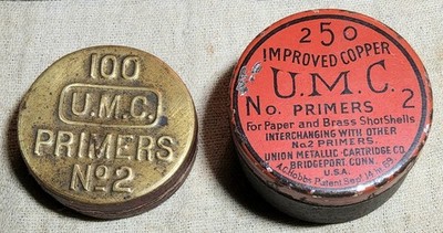 (2) ANTIQUE UMC PRIMERS EMPTY CIRCULAR TINS-RED COLOR 250 COPPER & BRASS 100 NO2