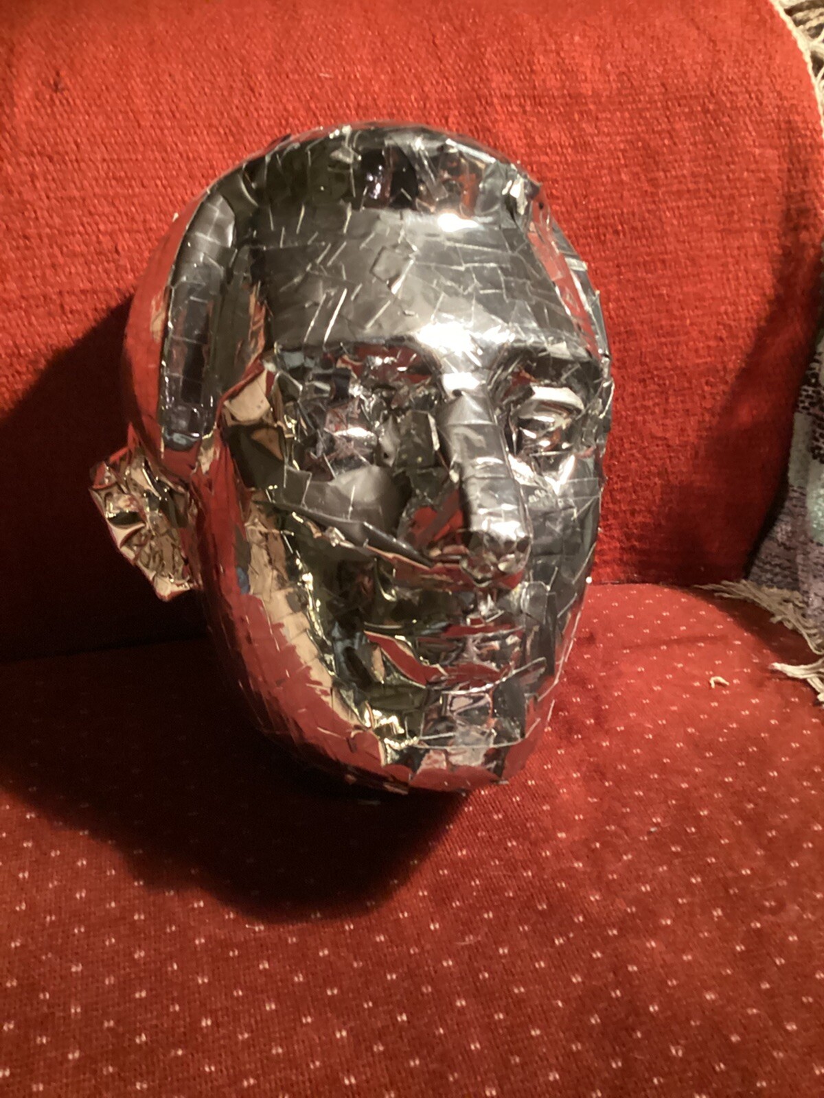 tinfoil covered man’s face mask, lifesized at 12” high x 10” wide x 10