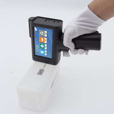 Handheld inkjet printer with ink prints text, barcode, batch number, and date