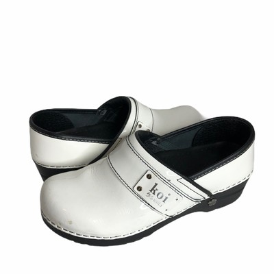white patent leather clogs