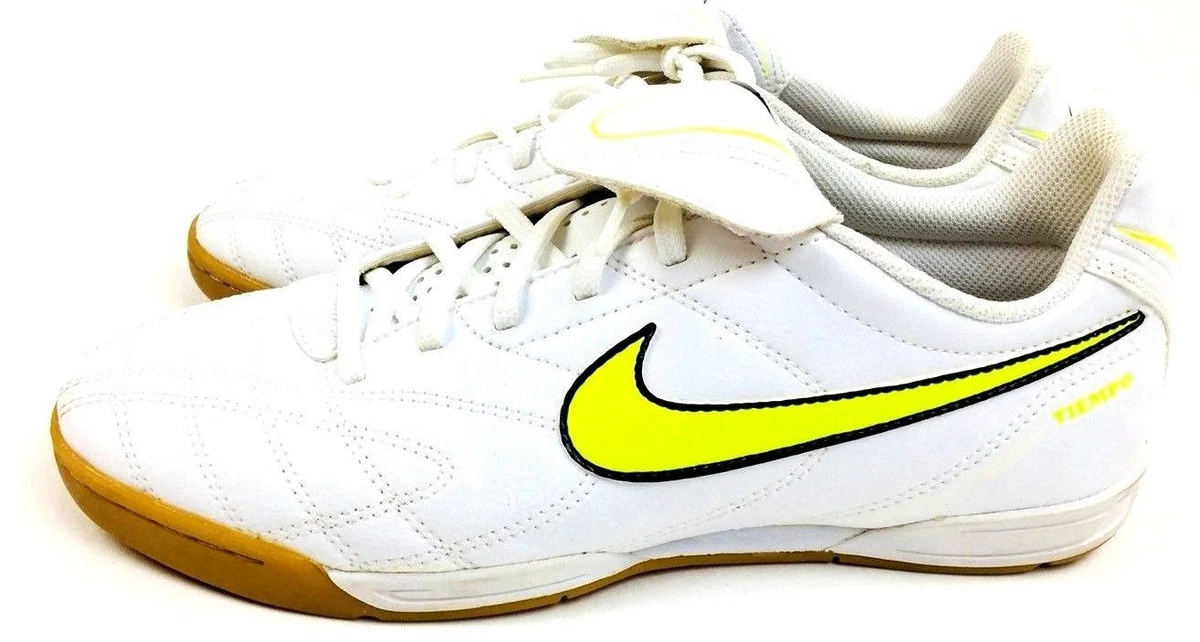 White nike shoes top with yellow swoosh