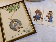 A Completed Cross Stitch Picture Of little girl in tyre swing.  Framed + 2 extra