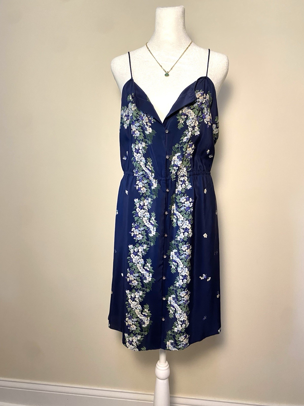 Navy floral silk slip dress with cap sleeves on a mannequin