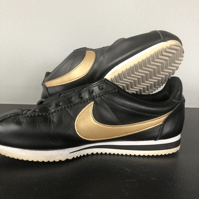 gold and black nike cortez