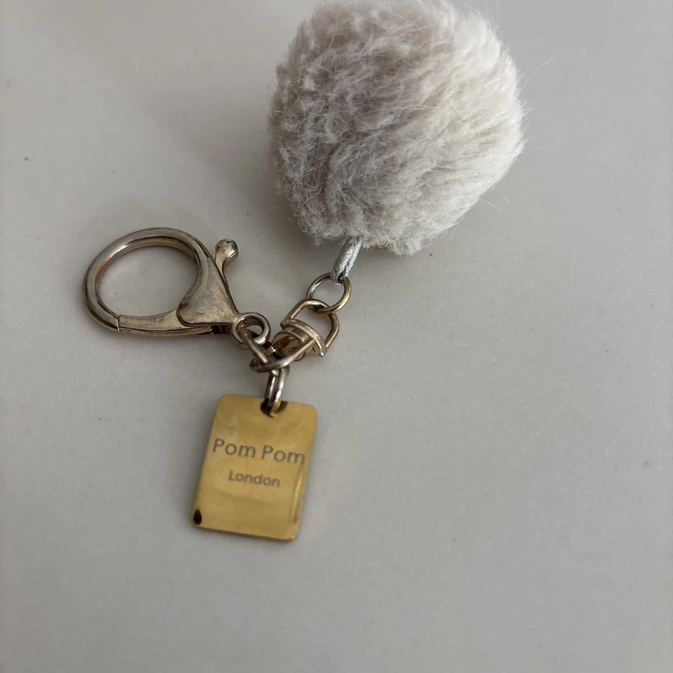 Accesorio de llavero Pom London beige con herrajes dorados para monedero Foto 4 de 4