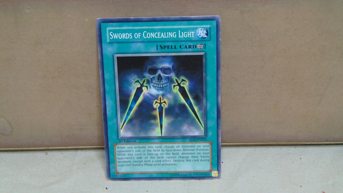 1996 YU'GI-OH! 1 ST EDITION SWORDS OF CONCEALING LIGHT SPELL CARD
