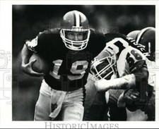 1989 Press Photo Bernie Kosar Breaks Through Arm Tackle by Michael Brooks