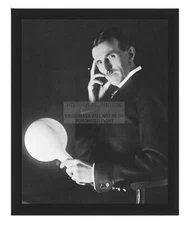 NIKOLA TESLA HOLDING TESLA POWERED LAMP INVENTER, ENGINEER 8X10 FRAMED PHOTO
