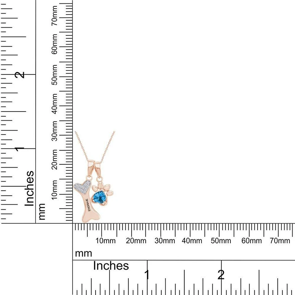 Colgante de topacio azul simulado con estampado de pata y hueso de perro en plata chapada en oro de 14 k Foto 4 de 4