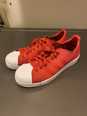 red adidas shell toe shoes