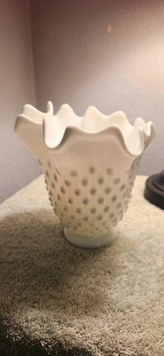 Vintage Fenton white milk glass hobnail bowl with a ruffled or crimped edge.