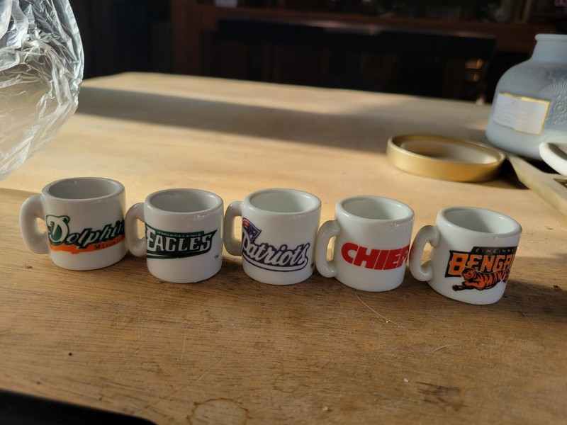 Set of collectible vintage NFL mini ceramic mugs featuring team logos