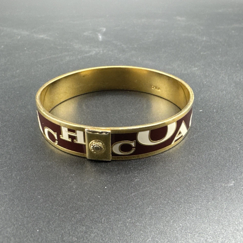 Brazalete Brazalete Coach Metal Tono Dorado Logo Esmalte Marrón y Blanco Foto 4 de 4