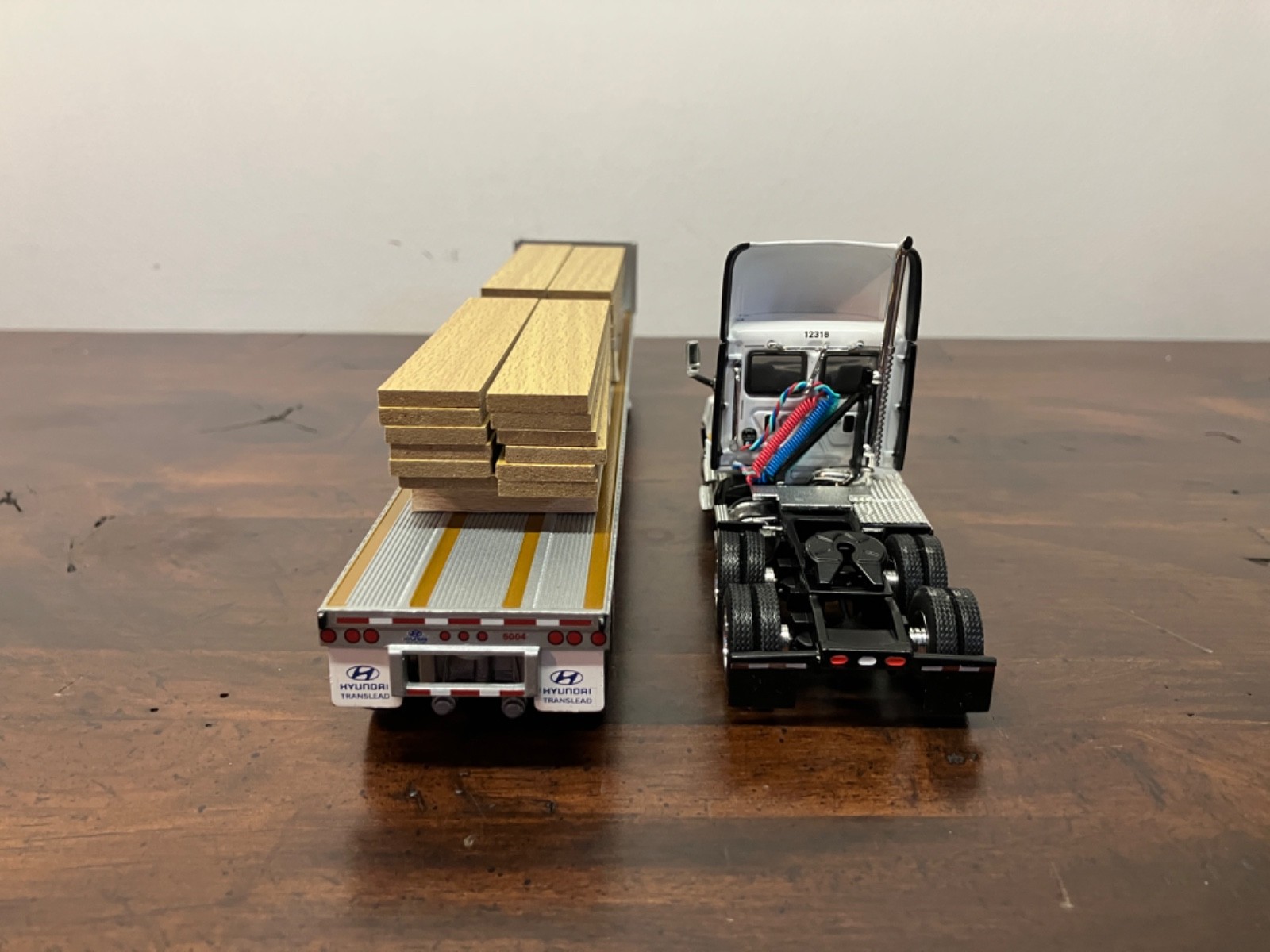 DCP First Gear 1/64th Osterkamp Trucking Cascadia Day Cab and 45' Flatbed w/load