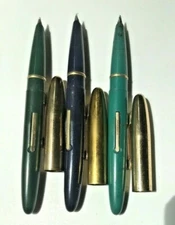 Lot of three Scripto fountain pens - two plain one advertising Pure Oil Company