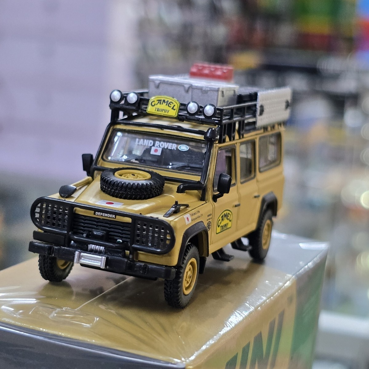 MINI GT LAND ROVER DEFENDER 110 1989 CAMEL TROPHY AMAZON